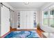 Bedroom with hardwood floors, a built-in wall unit with shelving, and a window with natural light at 116 Edgeview Ct, Dallas, GA 30157