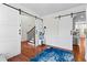 Open entryway featuring sliding barn doors, hardwood floors, staircase with iron spindles, and natural light at 116 Edgeview Ct, Dallas, GA 30157