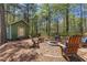Outdoor fire pit with chairs, a small shed, and mature trees at 116 Edgeview Ct, Dallas, GA 30157