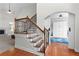 View of the foyer showing an open floor plan, hardwood floors, staircase, and view into the living room and adjacent room at 116 Edgeview Ct, Dallas, GA 30157