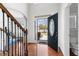 The foyer has hardwood floors, an ornate railing staircase, and a view through the decorative glass front door to the outdoors at 116 Edgeview Ct, Dallas, GA 30157