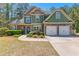 Charming two-story home featuring a two-car garage, stone accents, manicured landscaping and a walkway to the front door at 116 Edgeview Ct, Dallas, GA 30157