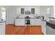 Gourmet kitchen boasting white cabinets, stainless steel appliances, and modern backsplash at 116 Edgeview Ct, Dallas, GA 30157