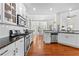 Bright kitchen featuring white cabinets, stainless steel appliances, and hardwood flooring at 116 Edgeview Ct, Dallas, GA 30157