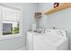 Laundry room with a washer and dryer, window and wire rack shelving at 116 Edgeview Ct, Dallas, GA 30157