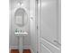 Powder room with pedestal sink and mirror at 116 Edgeview Ct, Dallas, GA 30157