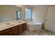 Bright bathroom with a soaking tub, double vanity, and tile flooring at 3005 Stonebrook Cv, Austell, GA 30106