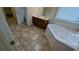 Bathroom with corner tub, double sinks and vinyl tile at 3005 Stonebrook Cv, Austell, GA 30106