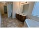 Bathroom featuring double vanity, large mirror, and a soaking tub at 3005 Stonebrook Cv, Austell, GA 30106