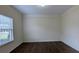 Bedroom with crown molding, wood-look floors and a large window with blinds at 3005 Stonebrook Cv, Austell, GA 30106
