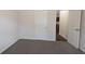 Comfortable bedroom featuring neutral carpet, white walls, and an open doorway at 3005 Stonebrook Cv, Austell, GA 30106