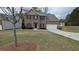 Charming two-story brick home features a manicured lawn, attached two-car garage, and welcoming front entrance at 3005 Stonebrook Cv, Austell, GA 30106