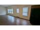 Open living space with wood-look flooring, a back door, and ample natural light from windows at 3005 Stonebrook Cv, Austell, GA 30106