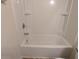 Bright shower and bath combination with built-in storage at 3005 Stonebrook Cv, Austell, GA 30106