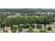Expansive aerial view of a residential community nestled amidst lush greenery and mature trees at 3335 Maple Terrace Dr, Suwanee, GA 30024