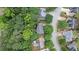 Aerial view showcasing a property surrounded by lush trees and neighborhood streets at 3335 Maple Terrace Dr, Suwanee, GA 30024