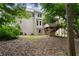 Home's backyard with a deck, lush greenery, mature trees, and well-maintained lawn at 3335 Maple Terrace Dr, Suwanee, GA 30024