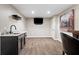 Basement wet bar with granite counters, cabinetry, and mounted TV, ideal for entertaining at 3335 Maple Terrace Dr, Suwanee, GA 30024