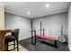 Basement features a home gym with weightlifting equipment and a bar area with seating at 3335 Maple Terrace Dr, Suwanee, GA 30024