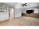 Finished basement with tile flooring, ceiling fan and mounted TV at 3335 Maple Terrace Dr, Suwanee, GA 30024