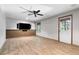 Finished basement with modern flooring, mounted TV, and walkout door at 3335 Maple Terrace Dr, Suwanee, GA 30024