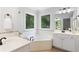 Bright bathroom with a soaking tub, vanity, and tile flooring at 3335 Maple Terrace Dr, Suwanee, GA 30024