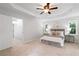 Comfortable bedroom with plush carpeting, a tray ceiling, and an attached bathroom at 3335 Maple Terrace Dr, Suwanee, GA 30024