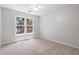 Bright bedroom featuring a large window for natural light and neutral carpet at 3335 Maple Terrace Dr, Suwanee, GA 30024