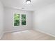 Bright bedroom with plush carpeting and a large window offering serene outdoor views at 3335 Maple Terrace Dr, Suwanee, GA 30024