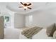 Open bedroom with plush carpeting, a tray ceiling, and a walk-in closet at 3335 Maple Terrace Dr, Suwanee, GA 30024