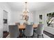 A dining room featuring a chandelier, wainscoting, and a view of the outdoors at 3335 Maple Terrace Dr, Suwanee, GA 30024