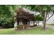 Inviting brick home with manicured lawn and mature trees, complemented by a two-car garage at 3335 Maple Terrace Dr, Suwanee, GA 30024