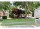 Beautifully landscaped front yard of a brick home, complete with mature trees and a two-car garage at 3335 Maple Terrace Dr, Suwanee, GA 30024