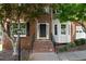 Front door with brick steps and a well-manicured landscape, with a two-car garage at 3335 Maple Terrace Dr, Suwanee, GA 30024