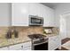 Close up of kitchen with stainless steel appliances, granite countertops and white cabinets at 3335 Maple Terrace Dr, Suwanee, GA 30024