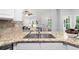 Kitchen featuring granite countertops, stainless sink, and an open view of the living area at 3335 Maple Terrace Dr, Suwanee, GA 30024