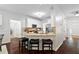 Bright kitchen features white cabinets, stainless steel appliances, granite countertops and breakfast bar with seating at 3335 Maple Terrace Dr, Suwanee, GA 30024