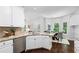 Bright kitchen with granite countertops, stainless steel dishwasher and view to eating nook at 3335 Maple Terrace Dr, Suwanee, GA 30024