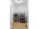 Bright laundry room with a side-by-side washer and dryer and neutral tile flooring at 3335 Maple Terrace Dr, Suwanee, GA 30024