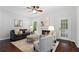 Comfortable living room with a ceiling fan, fireplace, plush seating, and hardwood floors at 3335 Maple Terrace Dr, Suwanee, GA 30024
