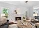 Cozy living room with a fireplace, hardwood floors, and stylish decor at 3335 Maple Terrace Dr, Suwanee, GA 30024