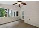 Bright sunroom with a neutral carpet, many windows, and access to the backyard at 3335 Maple Terrace Dr, Suwanee, GA 30024