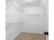 Spacious walk-in closet provides ample storage with multiple shelves and organized racks at 3335 Maple Terrace Dr, Suwanee, GA 30024