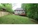 Back of the home with a cozy deck that overlooks the lawn and mature trees along the fenced lot line at 71 Anita Se Pl, Mableton, GA 30126