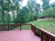 An elevated deck overlooks a lush backyard with mature trees at 71 Anita Se Pl, Mableton, GA 30126
