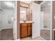 A well-lit bathroom with wood cabinets and an adjoining walk-in closet and doorway at 71 Anita Se Pl, Mableton, GA 30126