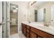 The bathroom boasts double sinks with wood cabinets and an open doorway to the bedroom at 71 Anita Se Pl, Mableton, GA 30126