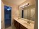Bright bathroom featuring a double vanity, large mirror, and neutral tones at 71 Anita Se Pl, Mableton, GA 30126