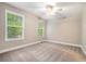 Bright bedroom with neutral carpeting, ceiling fan, and multiple windows at 71 Anita Se Pl, Mableton, GA 30126