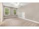 This bedroom features neutral carpet and paint, with ample natural light from the large windows at 71 Anita Se Pl, Mableton, GA 30126